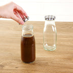 Restaurantware French Countryside 11 Ounce Glass Bottles 10 Durable Juice Bottles - With Black Plaid Lid Dishwashable Clear Glass Countryside Bottles For Hot And Cold Beverages